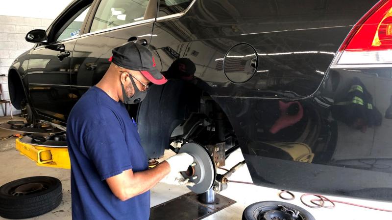 A Fleet Services technician works on a City vehicle