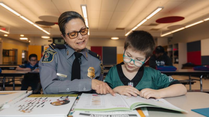 Lt Magyar helping child with math.