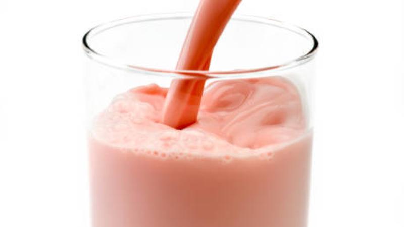 Picture of strawberry milk being poured into a glass
