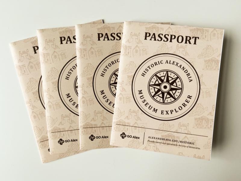 tan covers of four museum passports