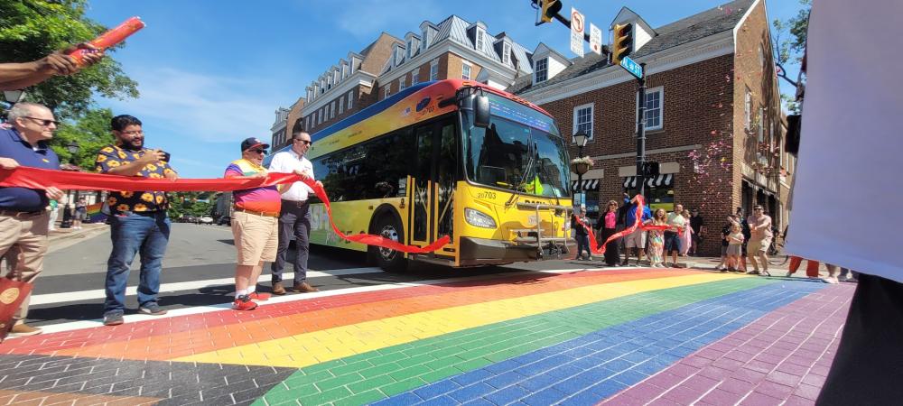 Pride bus cutting the ribbon at crosswalk dedication