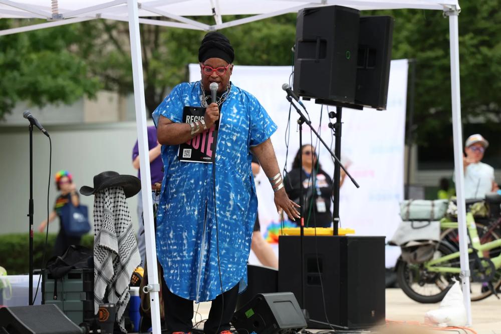 Person speaking on stage at Alexandria Pride 2026