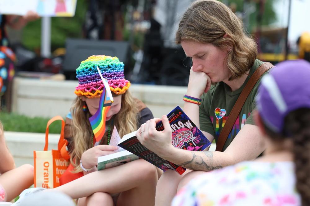 People reading in grass at Alexandria Pride 2026