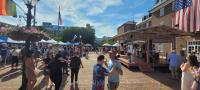 People dancing in front of stage at pride fair