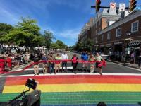 City council holding ribbon over new rainbow crosswalk