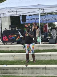 Speaker on stage at Alexandria Pride 2026