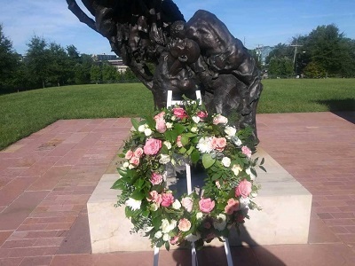 A wreath laid in front of the statue on the sixth anniversary of the memorial dedication