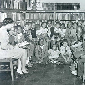 Story time to a group of children at the segregated Robinson Library