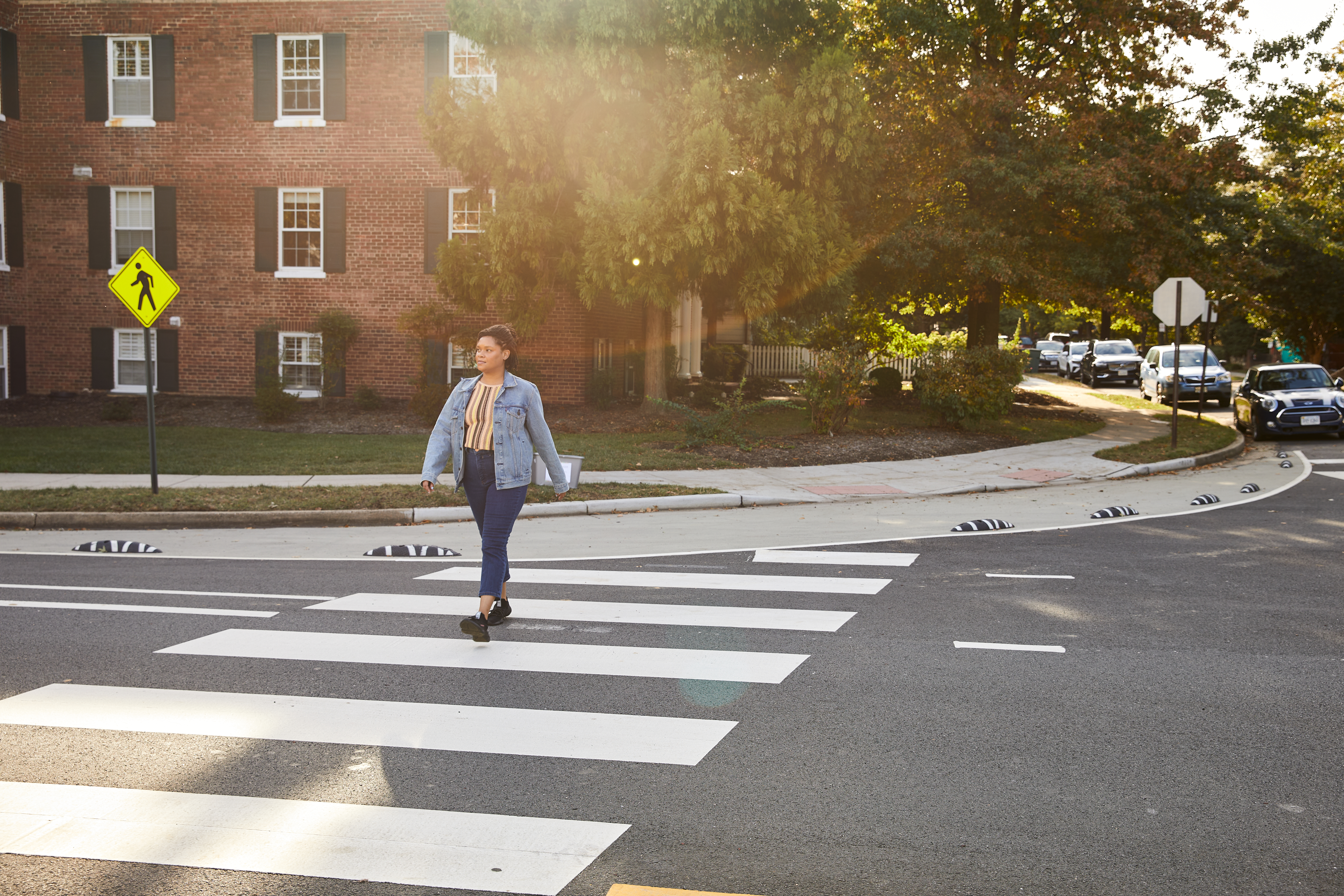 A pedestrian utilizes the upgraded crosswalk to cross Commonwealth Ave.