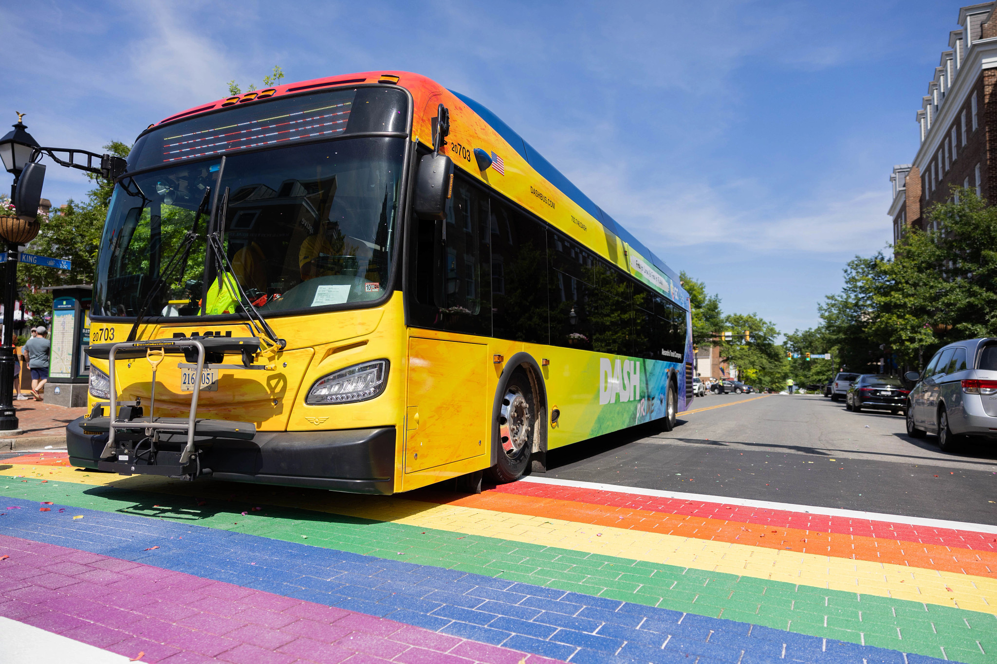 Pride wrapped DASH bus on rainbow crosswalk