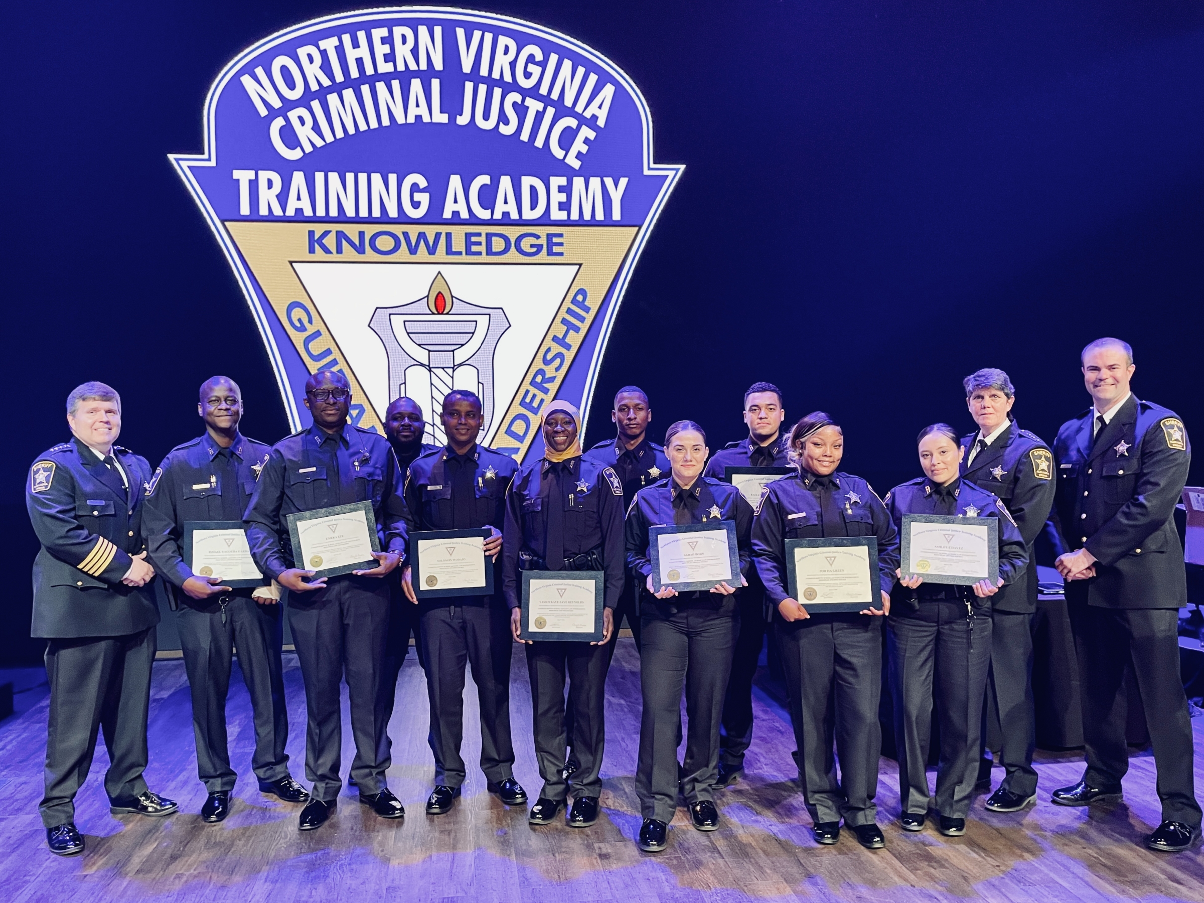Thirteen uniformed personnel, including Sheriff and ten recruits holding certificates, in from a large logo reading Northern Virginia Criminal Justice Training Academy
