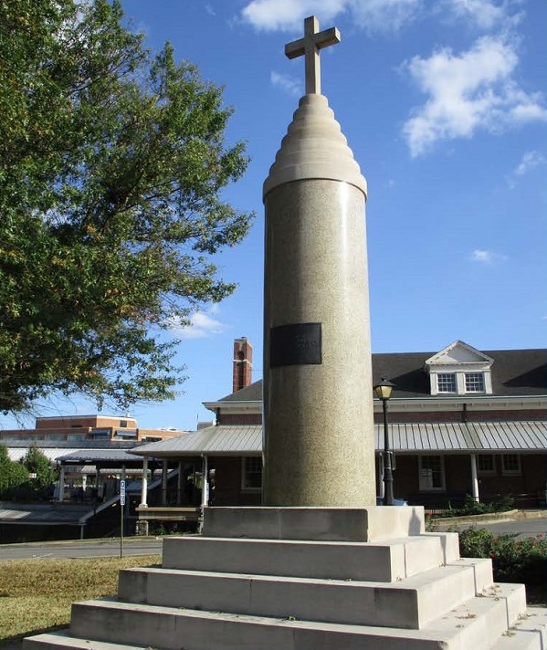 Marble war memorial with station in background