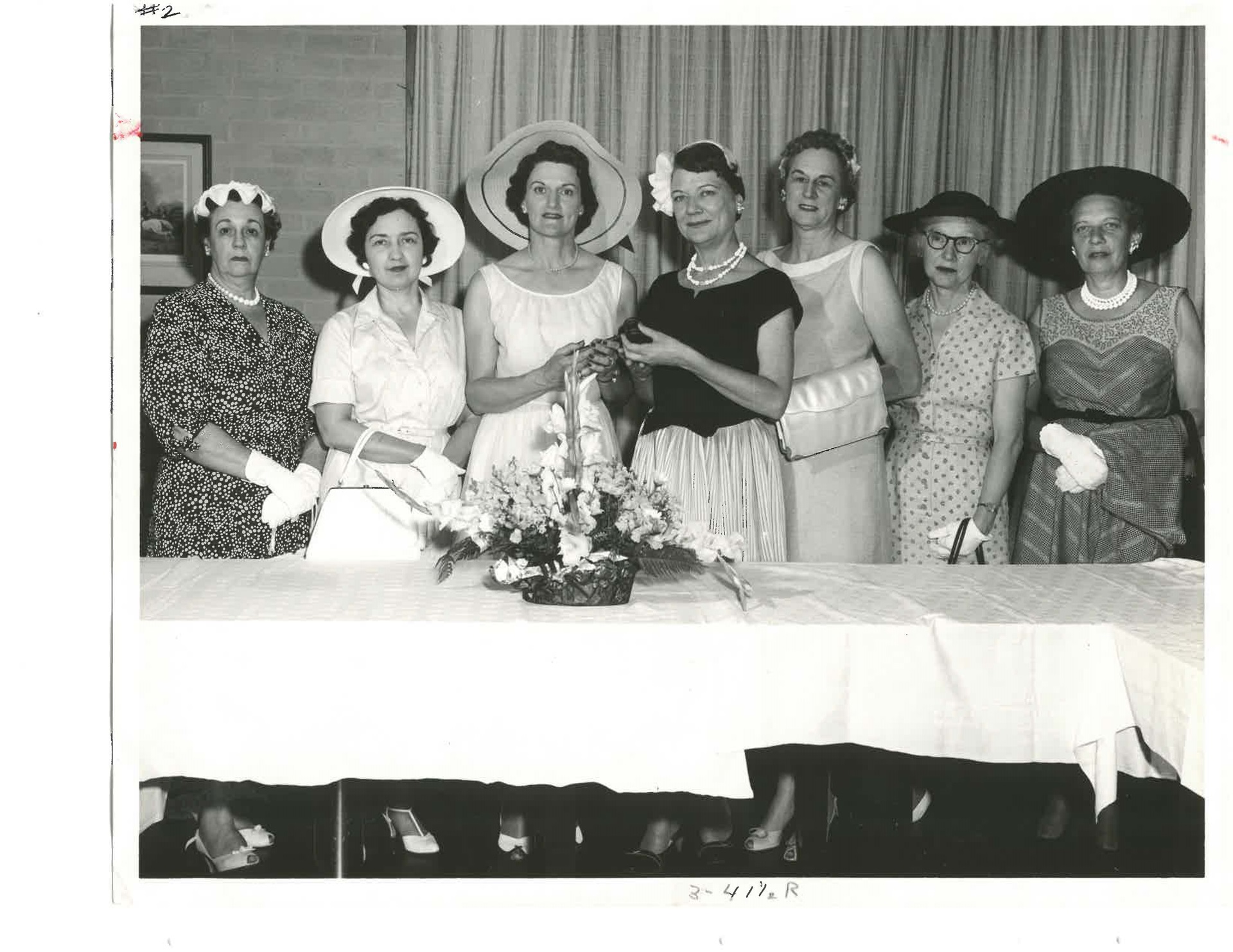 Women standing  behind table