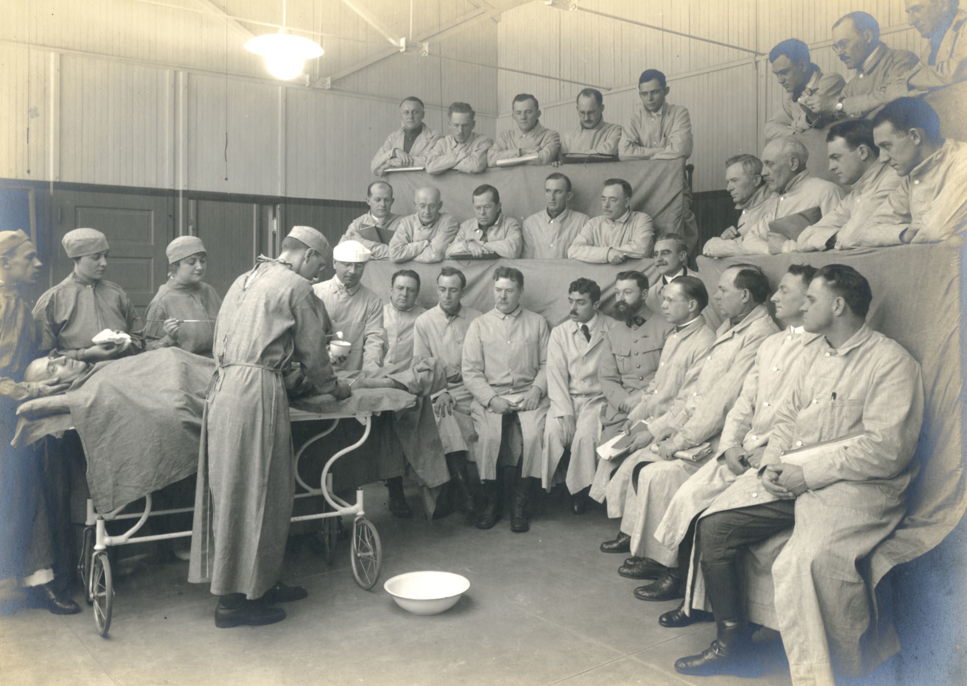 Early 20th century operating theatre with doctors observing