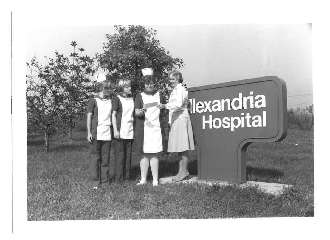 Check being presented in front of Alexandria Hospital sign