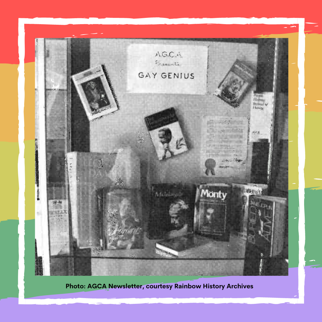 Black and white photo of library exhibit, with rainbow background