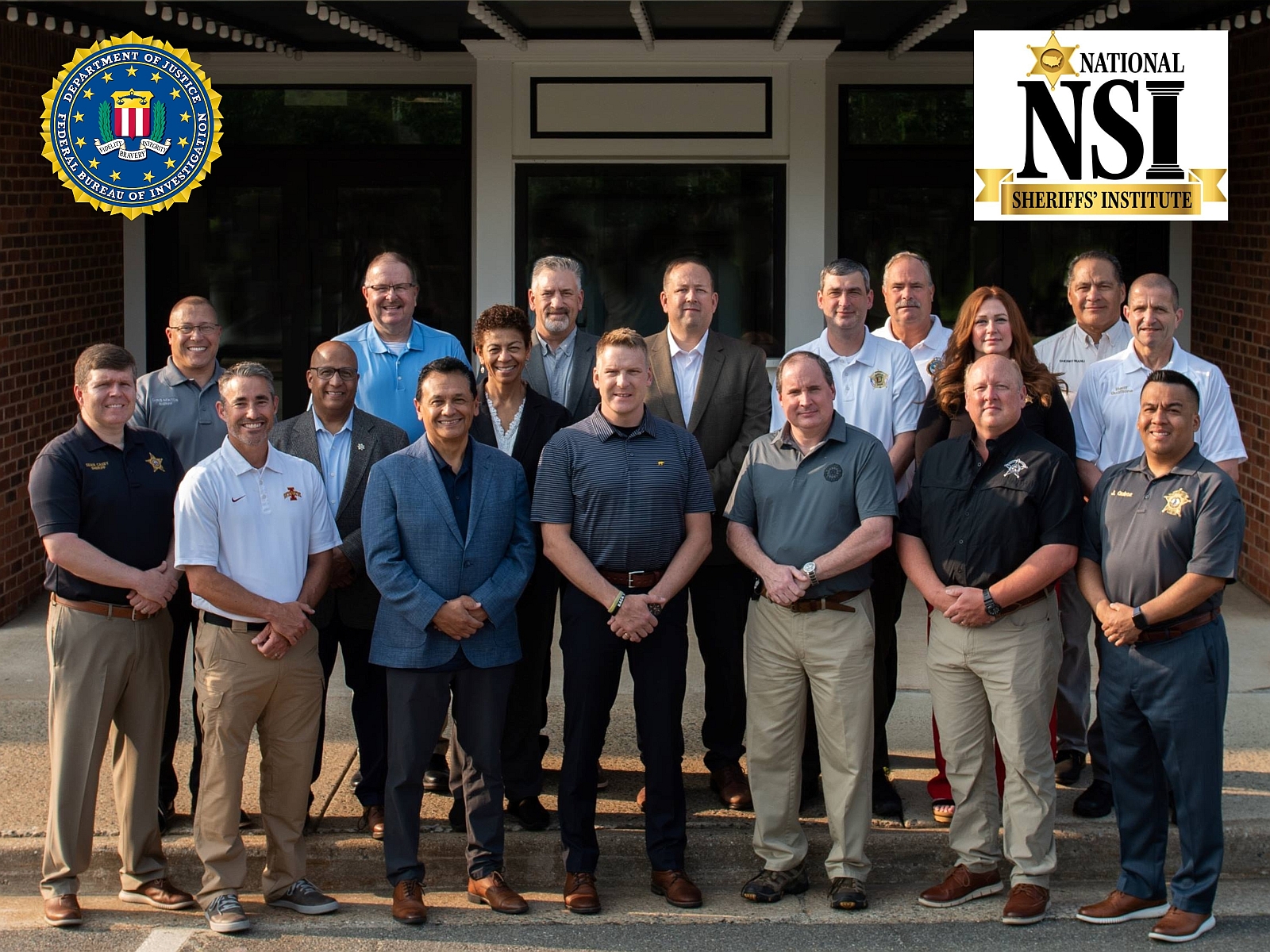 two rows of 18 law enforcement executives wearing business casual pants and agency golf-style shirts