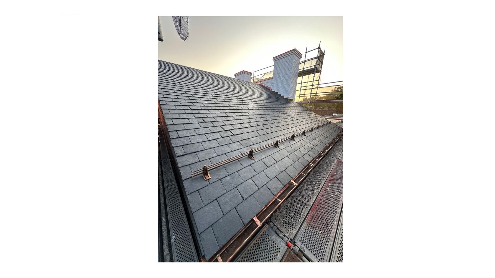 new slate roof and bronze snow guards and gutter