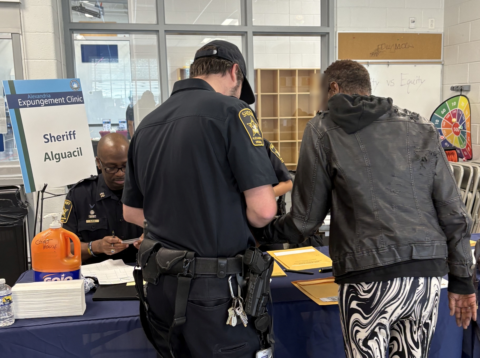 Deputy obtaining the fingerprints of an expungement petitioner at a community event