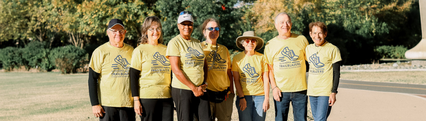 Image of seniors wearing yellow shirts that says Senior Trailblazers posing for the camera at Jones Point Park