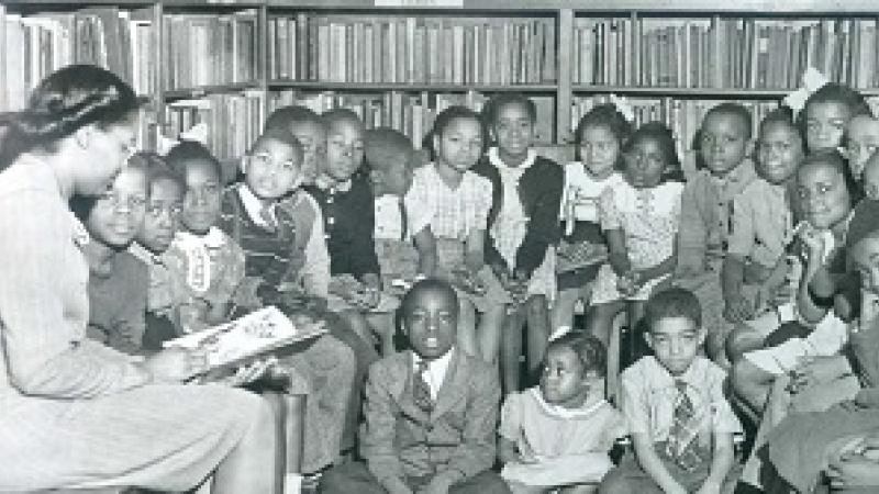 Story time to a group of children at the segregated Robinson Library