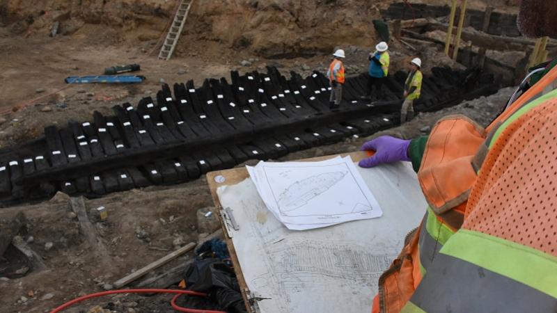Archaeologist recording a ship during excavation