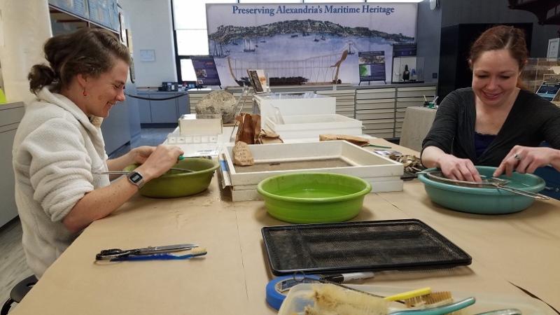 Archaeology volunteers washing artifacts