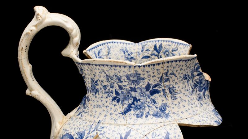 Whiteware pitcher with blue transfer print, pieced together from sherds