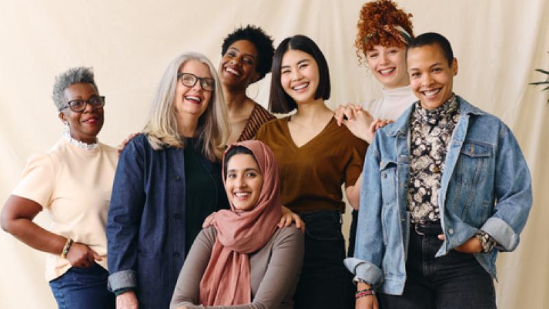 Portrait of mixed age range multi ethnic women smiling in celebration