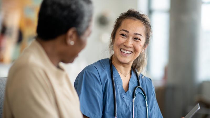 Photo of a doctor or nurse consulting with a patient