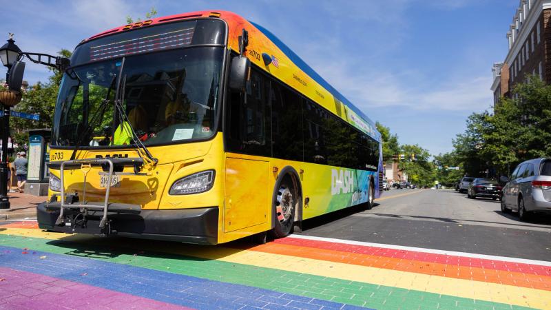 Pride wrapped DASH bus on rainbow crosswalk