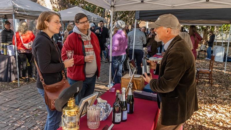Two people at a cider tasting table