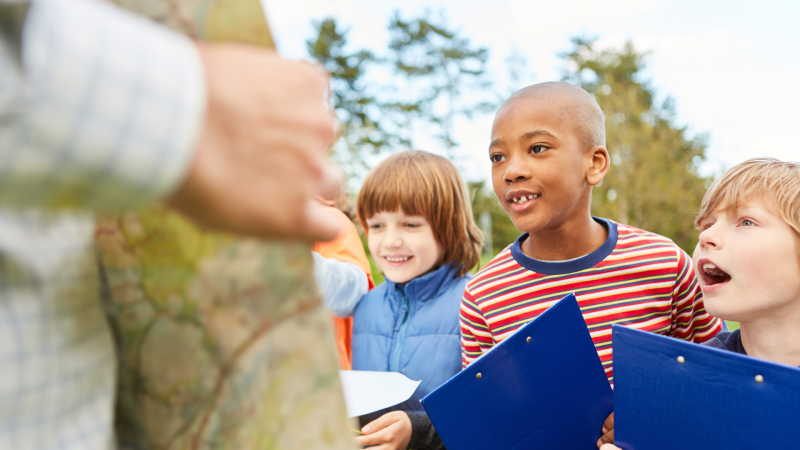 Three kids looking at a map for clues