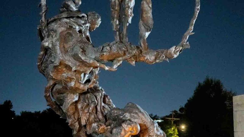 Statue with candles and wreath