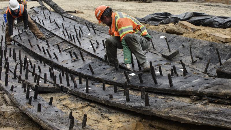 Archaeologists excavate an 18th century wooden ship at the Hotel Indigo Site (44AX229).