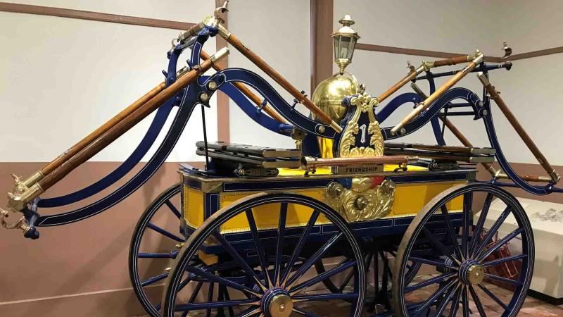 Newly restored pumper in museum, painted yellow and blue