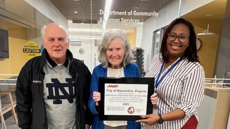 Staff holding AARP award