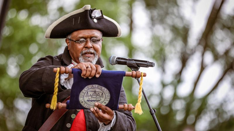 The town crier reading from a scroll