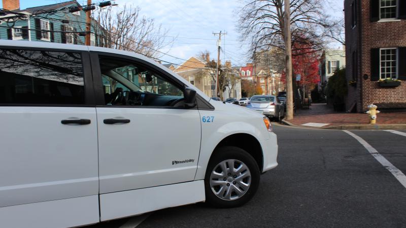 White paratransit van turning a corner