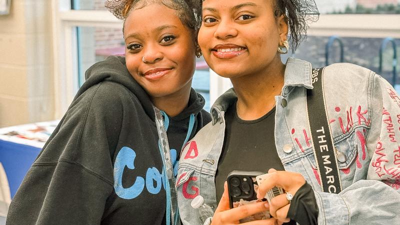 Two teen girls smiling at the camera
