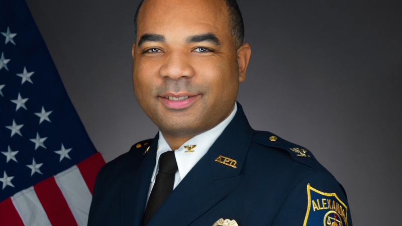Portrait of Chief Tarrick McGuire in his dress uniform with a United States flag in the background.