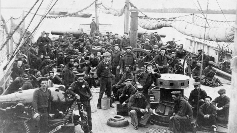 USS Miami crew - black and white photo of large crew on deck of sailing ship