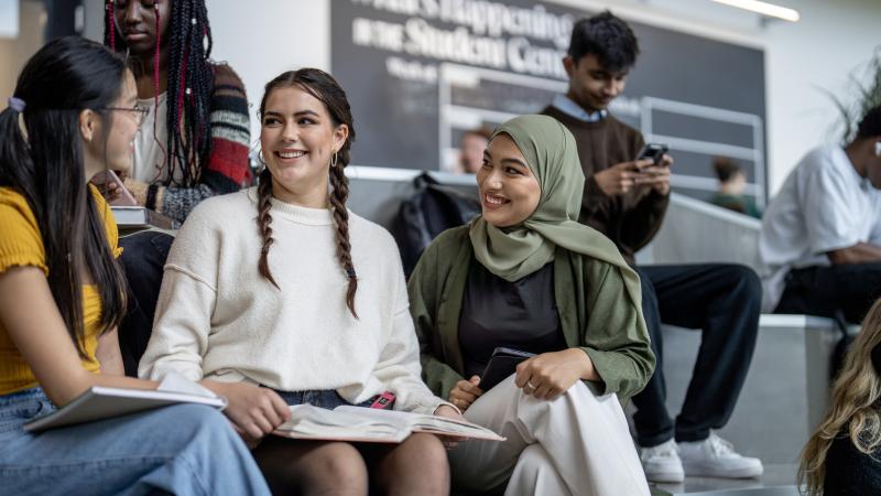 Group of teens sitting and smiling at each other
