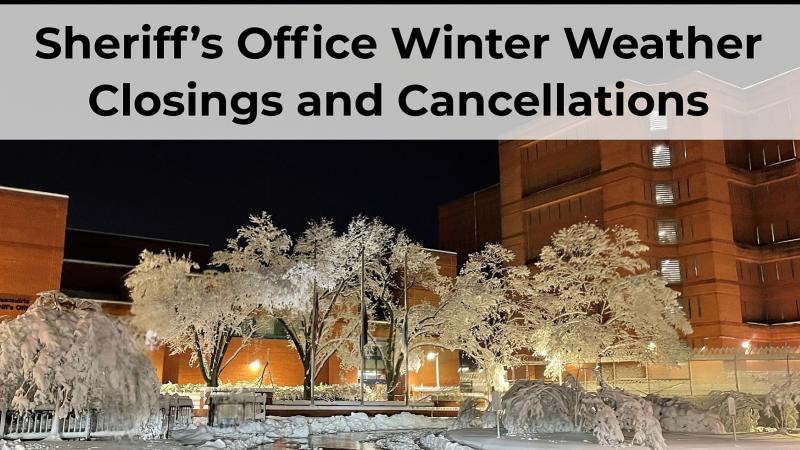 snow covered trees and ground with jail in background at night and message: Sheriff's Office Winter Weather Closings and Cancellations
