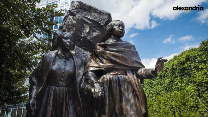 edmonson sisters statue with visit alexandria logo in top right corner