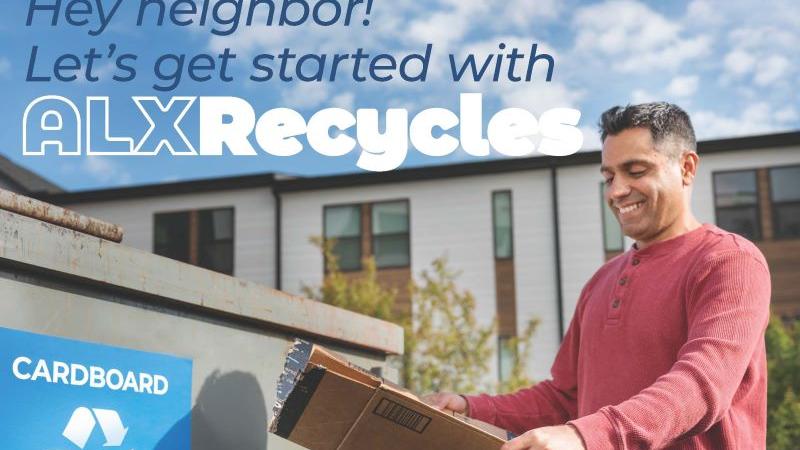 A person putting cardboard in the recycling dumpster.