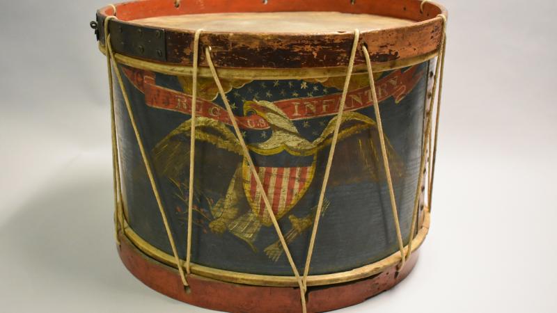 The drum is decorated with an American eagle and the words “Regimental Infantry in gold on a red ribbon.