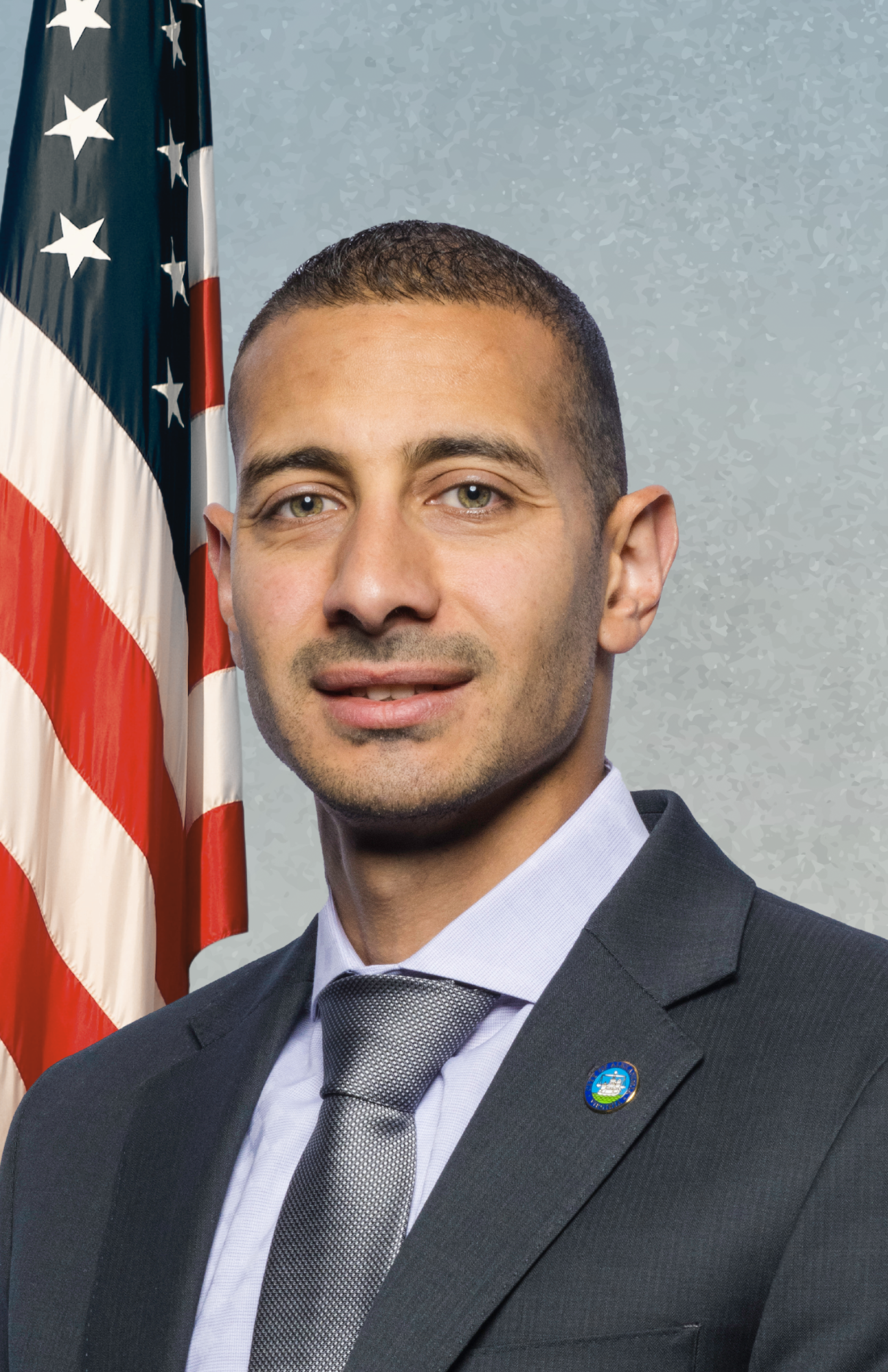 councilman elnoubi on blue background with american flag