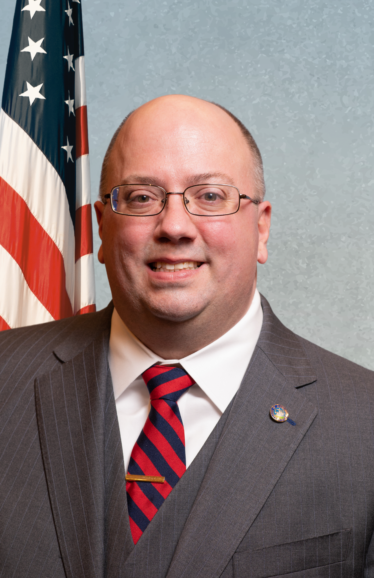 councilman mcpike on blue background with american flag