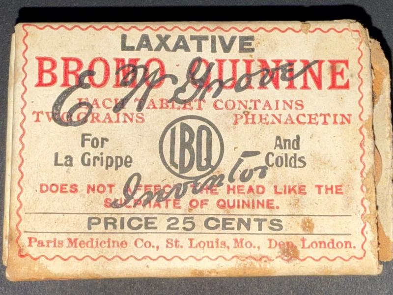 Small 2.5 by  1.5" yellow-ish box that reads "Laxative Bromo Quinine each tablet contains two grains phenacetin. For La Grippe and Colds. Does not effect the head like the sulphate of quinine. Price 25 cents. Paris Medicine Co., St. Louis, Mo. Dep. London. Box contains small round brown tablets.